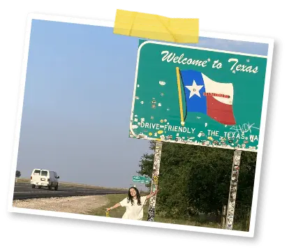 Girl standing beneath a road sign saying 'Welcome to Texas'.png